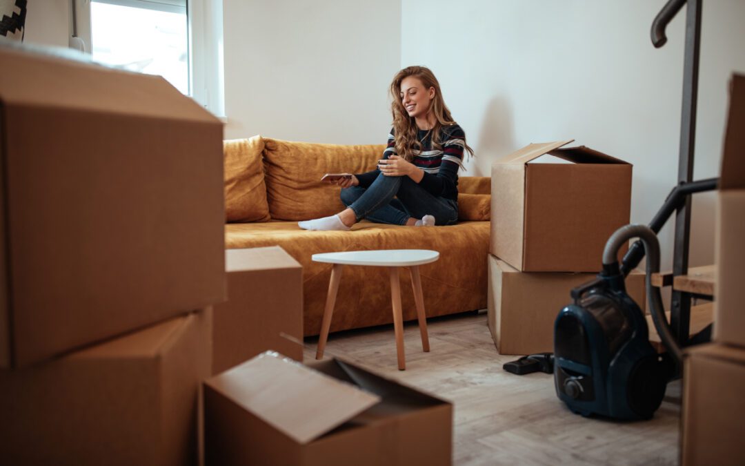 Smooth Move Moving Services in South Carolina | woman sitting on couch surrounded by cardobard boxes